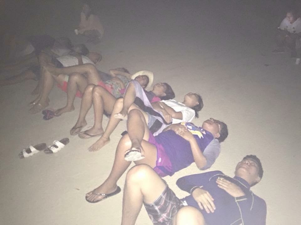 The team lounged on the sand, basking in the tranquility of the night in Bantayan.