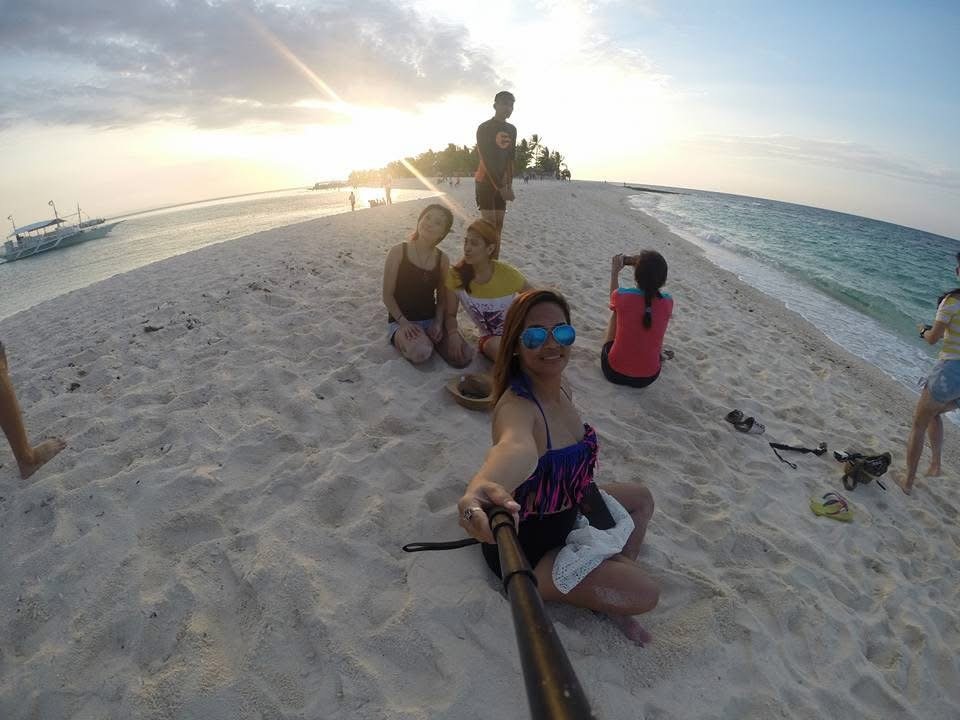 Long white sandbar surrounded by turquoise water at Kalanggaman Island